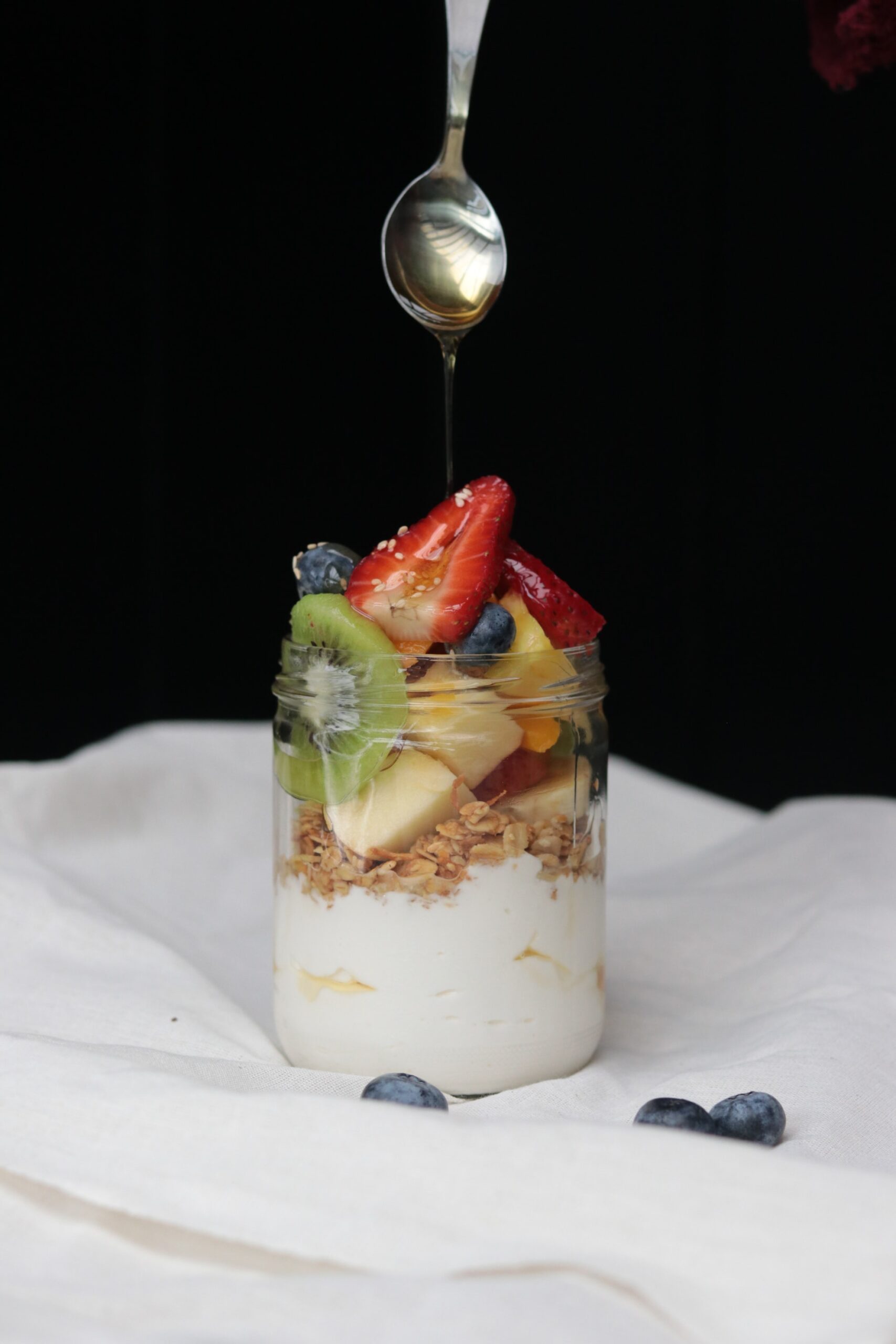 Mason jar with yogurt, granola and fruit